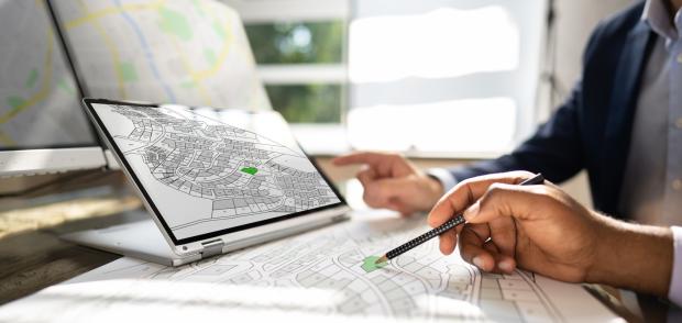 Cadastre Map And City Building Survey On Laptop