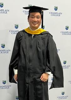 Asian male in graduation regalia portrait