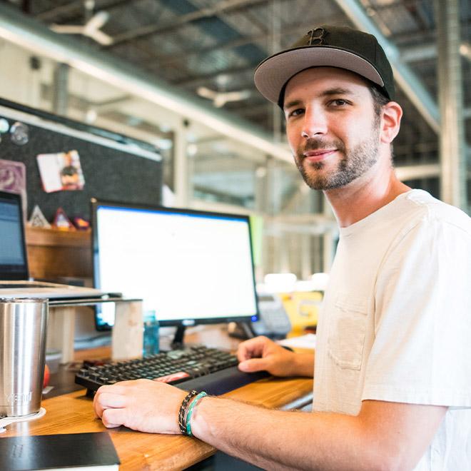 Online advanced business certificate student at work in front of computer 