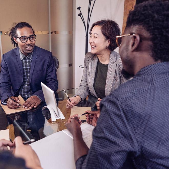 Group of coworkers sitting around a table talking