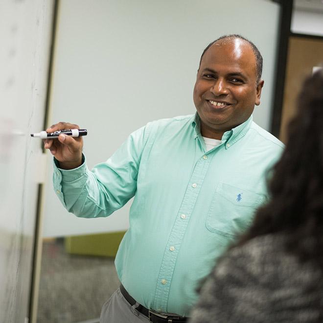 General studies online bachelor's degree graduate presenting work to colleague