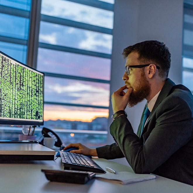 Cybersecurity professional on a computer in an office